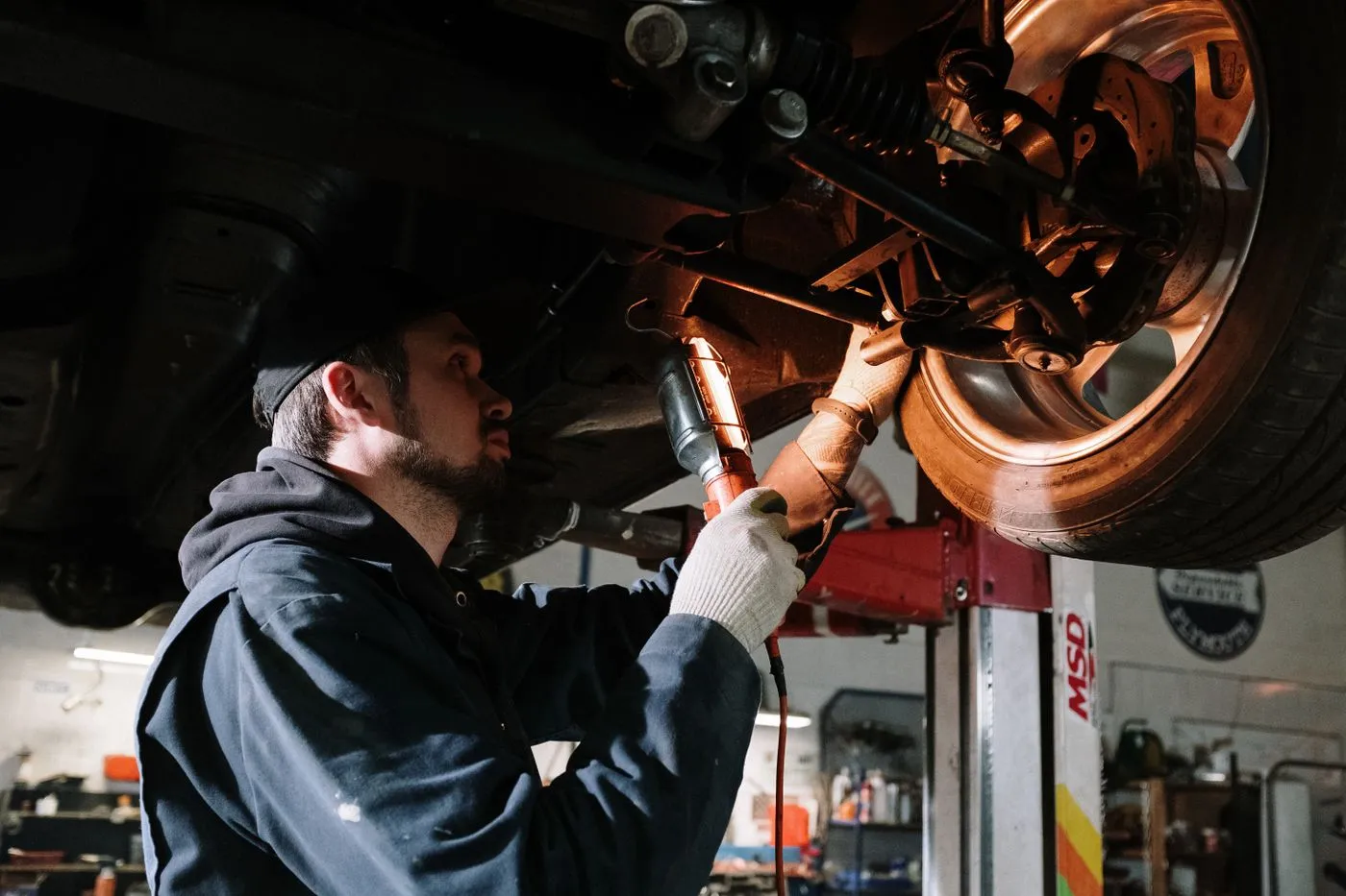 Mobile mechanic working under a vehicle